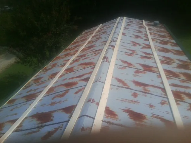 Rusted metal roof panels with new wood purlins before replacement — Storm Damage Roof Repair in Landis by Roofing Brothers